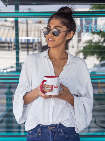 woman holding a white mug with red handle and inside, Go Red logo on side 