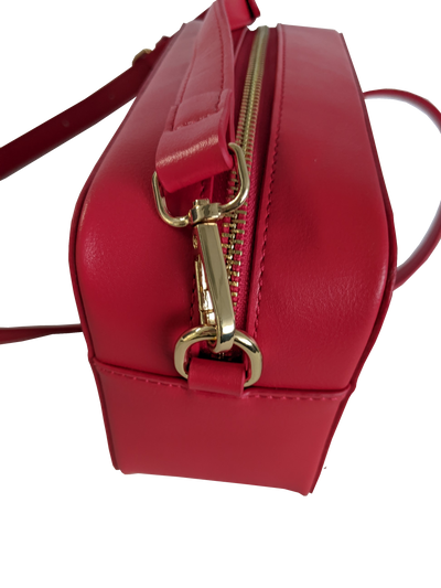 Side of purse showing zipper and strap clasp.