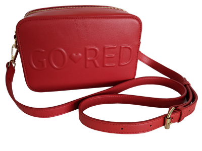 Red purse with gold zipper, claps, and strap buckle. "Go Red" with a small heart in between the words embossed in the center of the rectangle purse. 