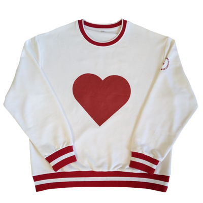 Front of white sweatshirt has a large red heart.  AHA name and logo on sleeve. neck and cuffs have red stripes for a varsity look. 