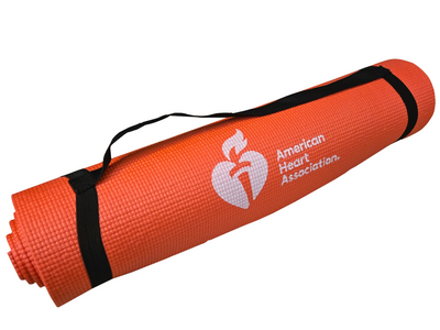 Red rolled up yoga mat with black carrying strap. White AHA logo with heart and torch featured at bottom of mat.