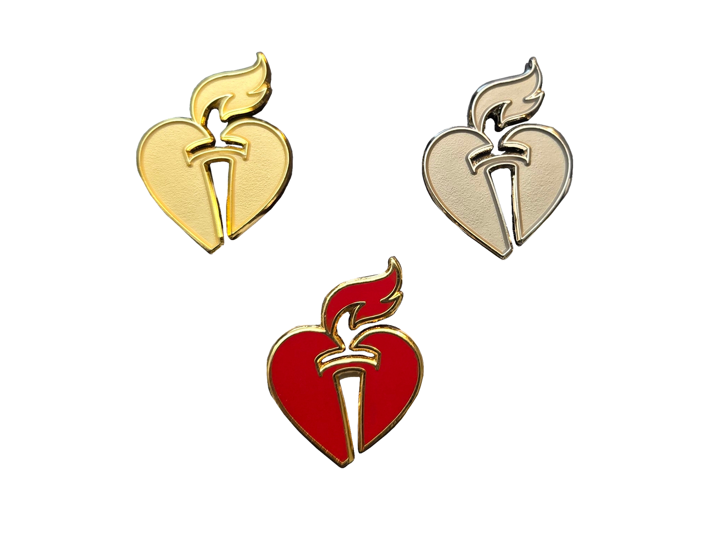 Three heart and torch lapel pins: gold, silver and red.