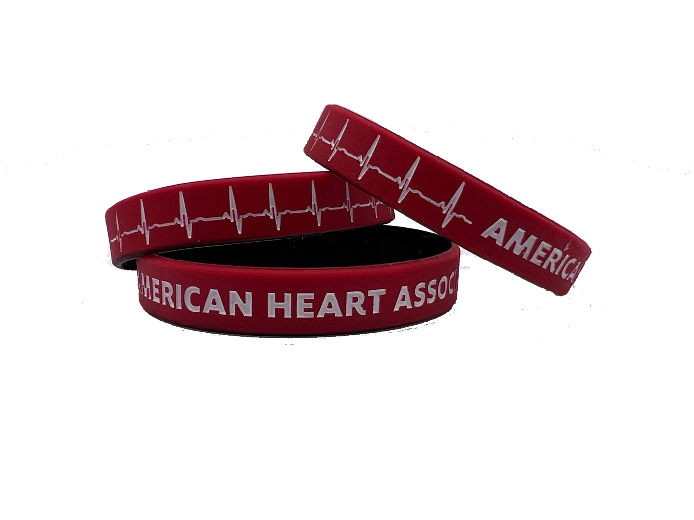 stack of 3 wristbands, red with black on inside. Printed on outside with white EKG line and "American Heart Association"