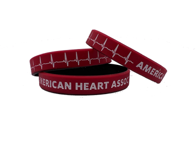 stack of 3 wristbands, red with black on inside. Printed on outside with white EKG line and "American Heart Association"